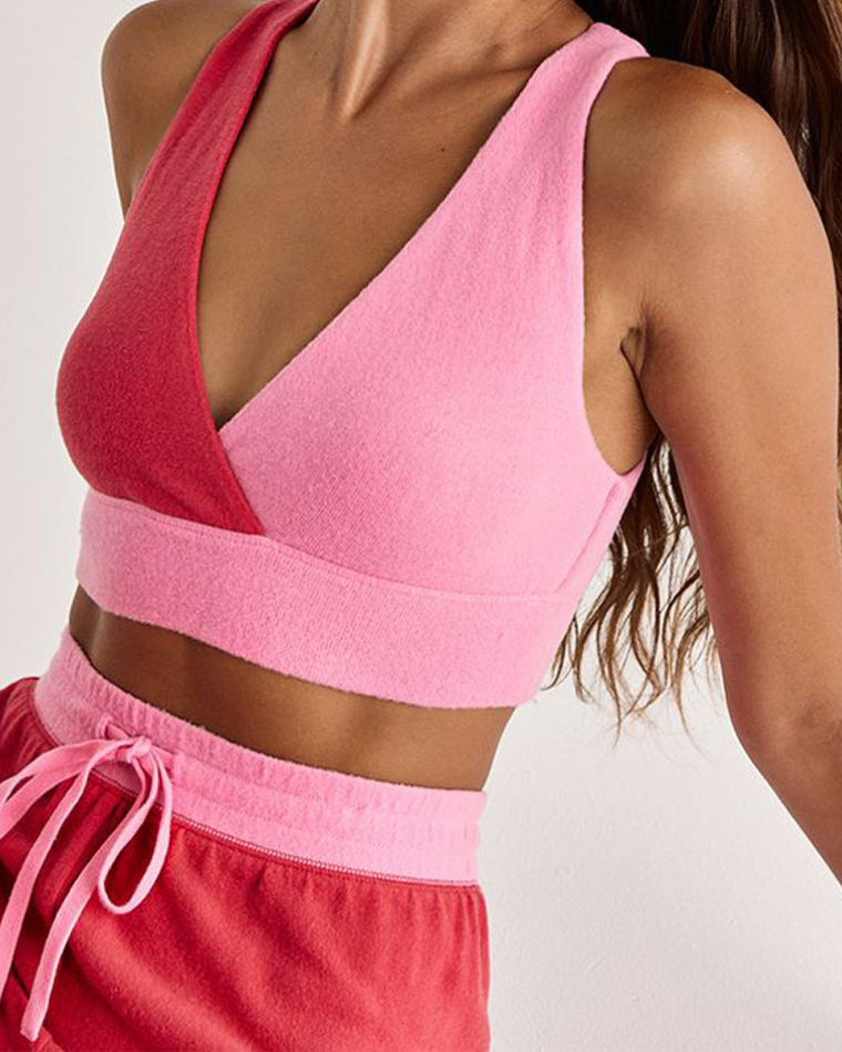 Woman wearing comfy lingerie - a pink color block z-supply lounge bra from Wantable Sleep & Body Edit