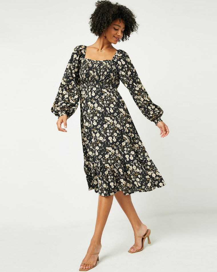 Woman wearing a flowy black floral dress from Wantable's cute holiday dresses in Style Edit