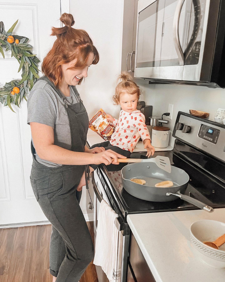 Mother and toddler making pancakes - one of the many ways to be present during the holidays - @hellobrownfamily
