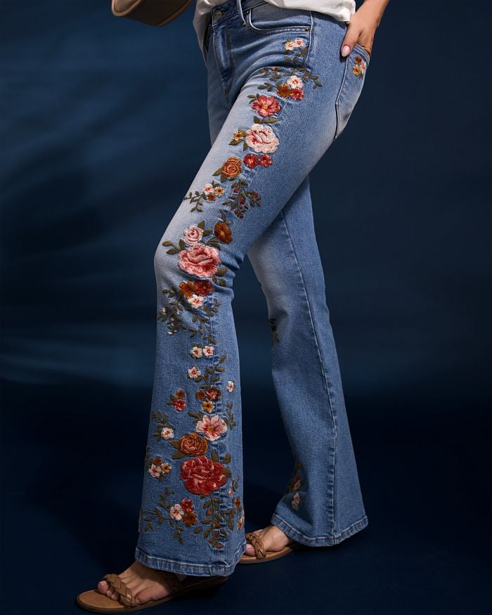Floral embroidery down the side of a pair of flare jeans.