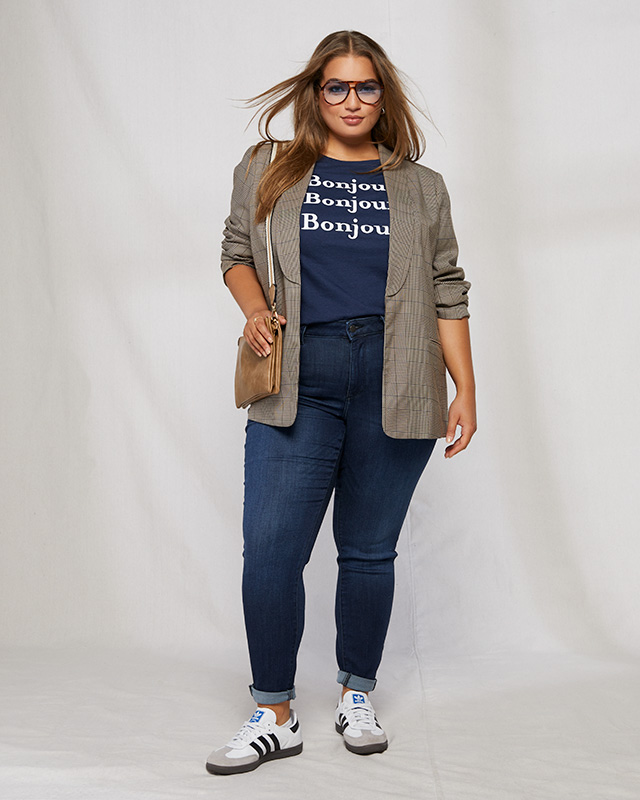 Plaid blazer styled with skinny jeans, sneakers, and a graphic t-shirt.