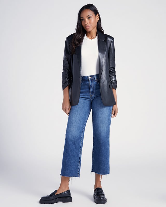 A faux leather ruched sleeve blazer styled with a simple white tee and high waisted jeans.