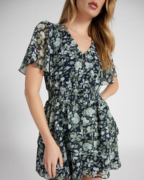 An up-close image of a Wantable model wearing a mini-length fit-and-flare dress with a floral print. Example of spring dresses. 