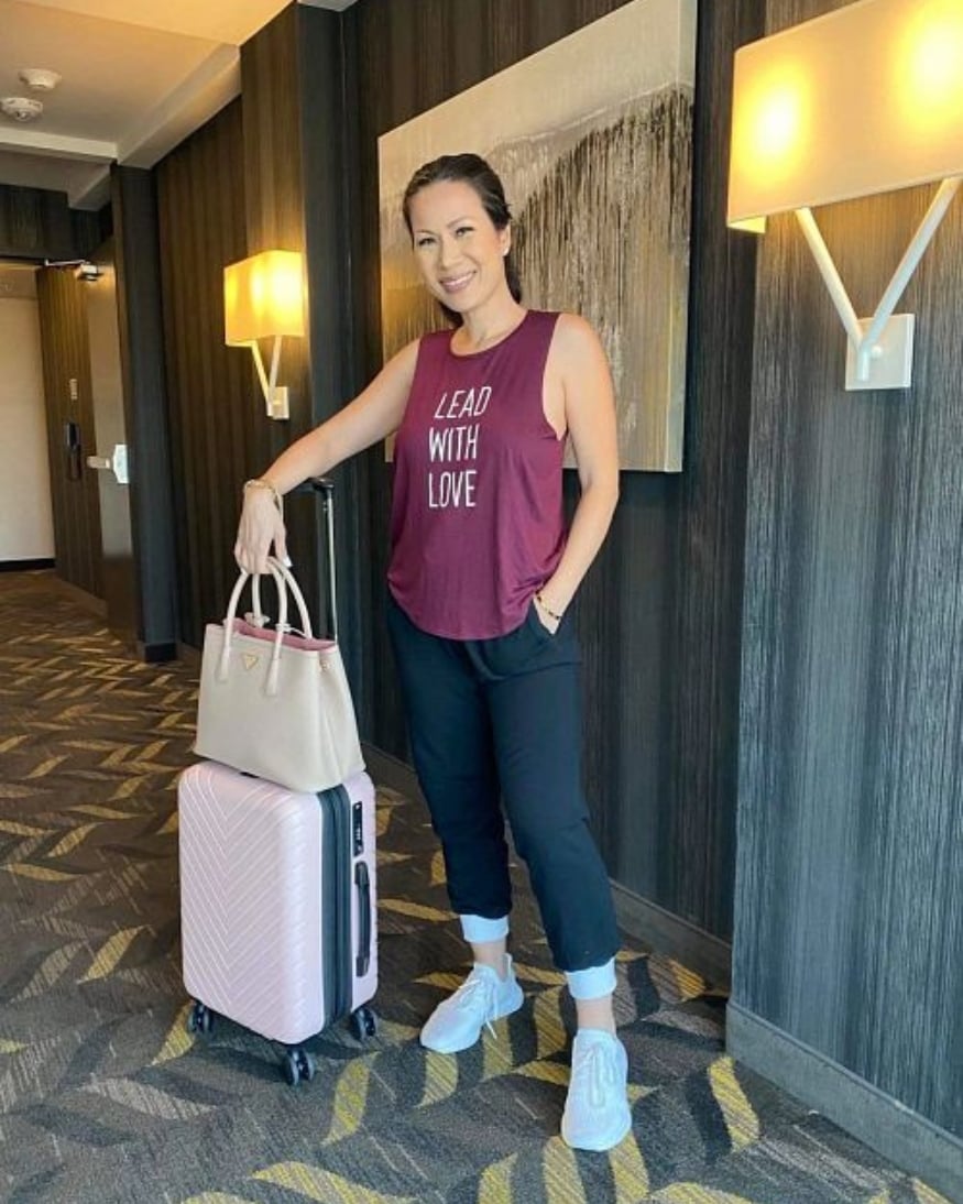 A Wantable influencer ready for her flight in a cute graphic tank and loose-fitting joggers. 