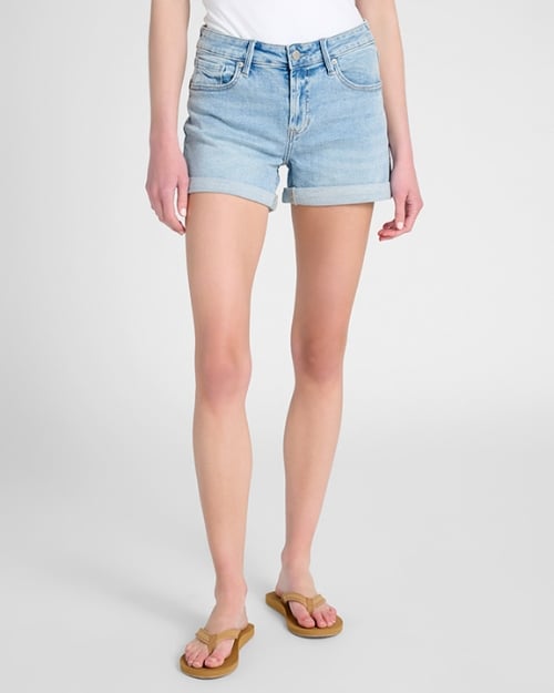 A photo of a Wantable model facing the camera and wearing a pair of cuffed denim boyfriend shorts. 