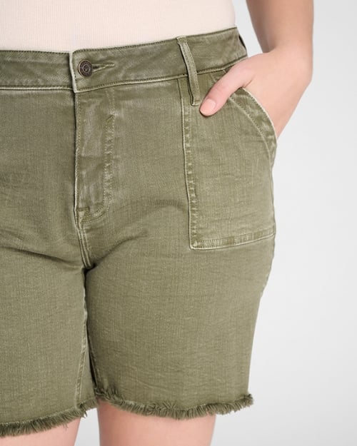 An up-close photo of a Wantable model wearing a pair of green denim Bermuda shorts. One of her hands is in her pocket. 