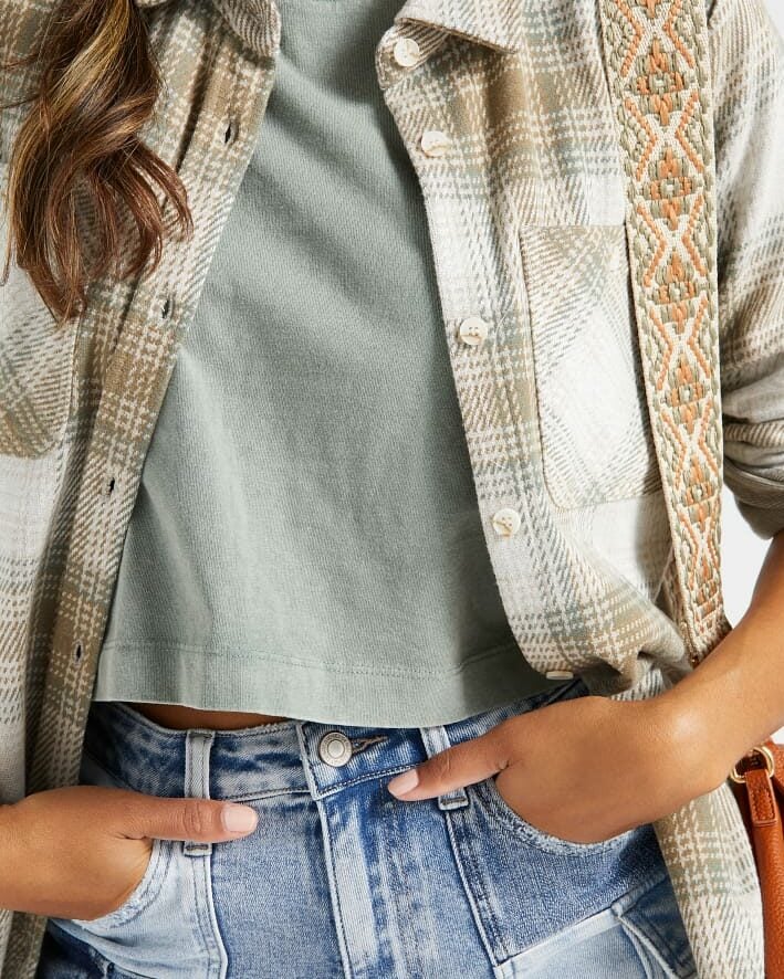 Close up of layering for a backyard party with a tank top and plaid shirt.
