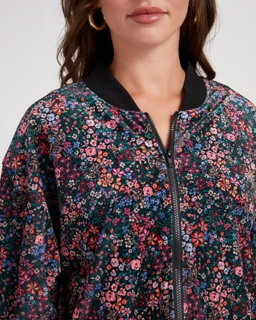 Close-up of a floral patterned suede bomber jacket.