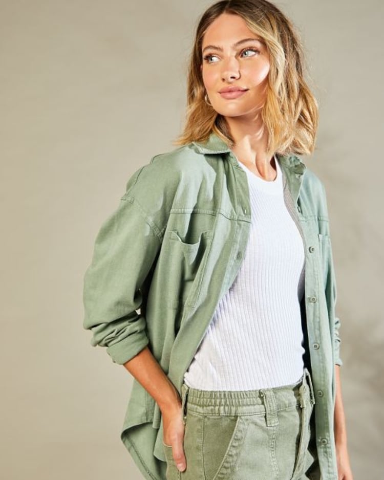 Close up of model wearing classic green cargos with matching green jacket and a white tee.