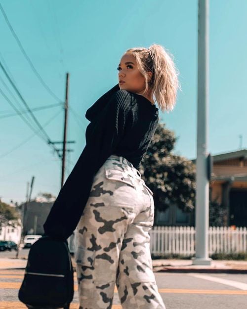 Influencer wearing a pair of camo patterned cargo pants. Fun patters are a great way to style cargo pants.